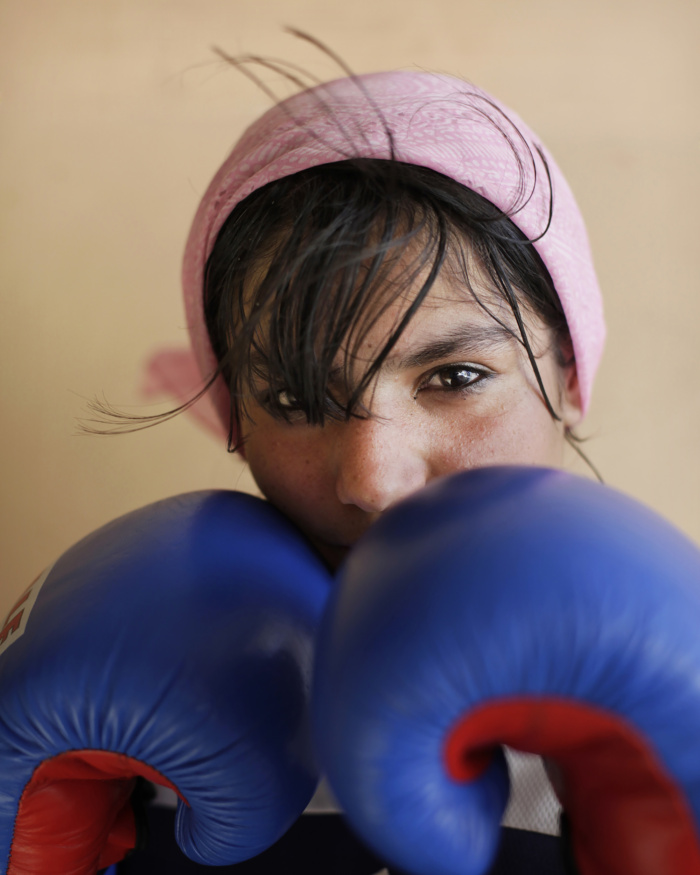 Abbie Trayler-Smith  Sadaf Haruzel, 17, a member of the Girls's Boxing TEam in Kabul, photographed at The National Stadium.
Olympic Dreams: Fighting for Peace
Boxing is making a comeback in Afghanistan after it was banned by the Taliban Regime.  For the first time in the history of Afghanistan the country also now has an Afghan Amateur Women’s Boxing Association, financed and established by CPAU under the auspices of The Afghan Olympic Federation.Afghanistan’s first female boxing team has fought hard to be accepted in Afghan society.  A group of teenage girls, aged 14 to 20, train 3 times a week at the dingy National Stadium in Kabul, once used for Taliban executions.  And now, with Women’s Boxing tipped to become an Olympic sport, the girls are fighting for their chance to travel to the UK as part of Afghanistan’s first female Olympic boxing team for London 2012.
.
Shabnam, 17, is one of three sisters in the team. She has been boxing since she was 11 and has already taken part in an international competition in Vietnam. She says: “I want to win a medal for myself and for my country. Afghanistan has been through a lot during my lifetime. I want to make my country proud. Why shouldn’t girls do it? In Afghanistan now we can do anything”Saber Sharifi a fit 50-year-old who became Afghanistan’s boxing star in the 1980s by winning a silver medal at the 1982 Asia Games in Delhi, has become a champion of the programme and its coach.
“Afghan women are brave,” he said. “We want our girls to do sports. Some people say it is very dangerous for girls to do boxing. Others say Afghanistan is not ready for this. These girls are proving those people wrong.”